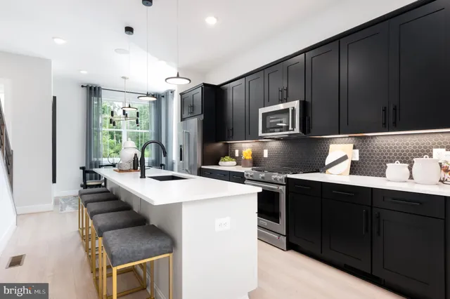 a kitchen that has a sink and a stove in it