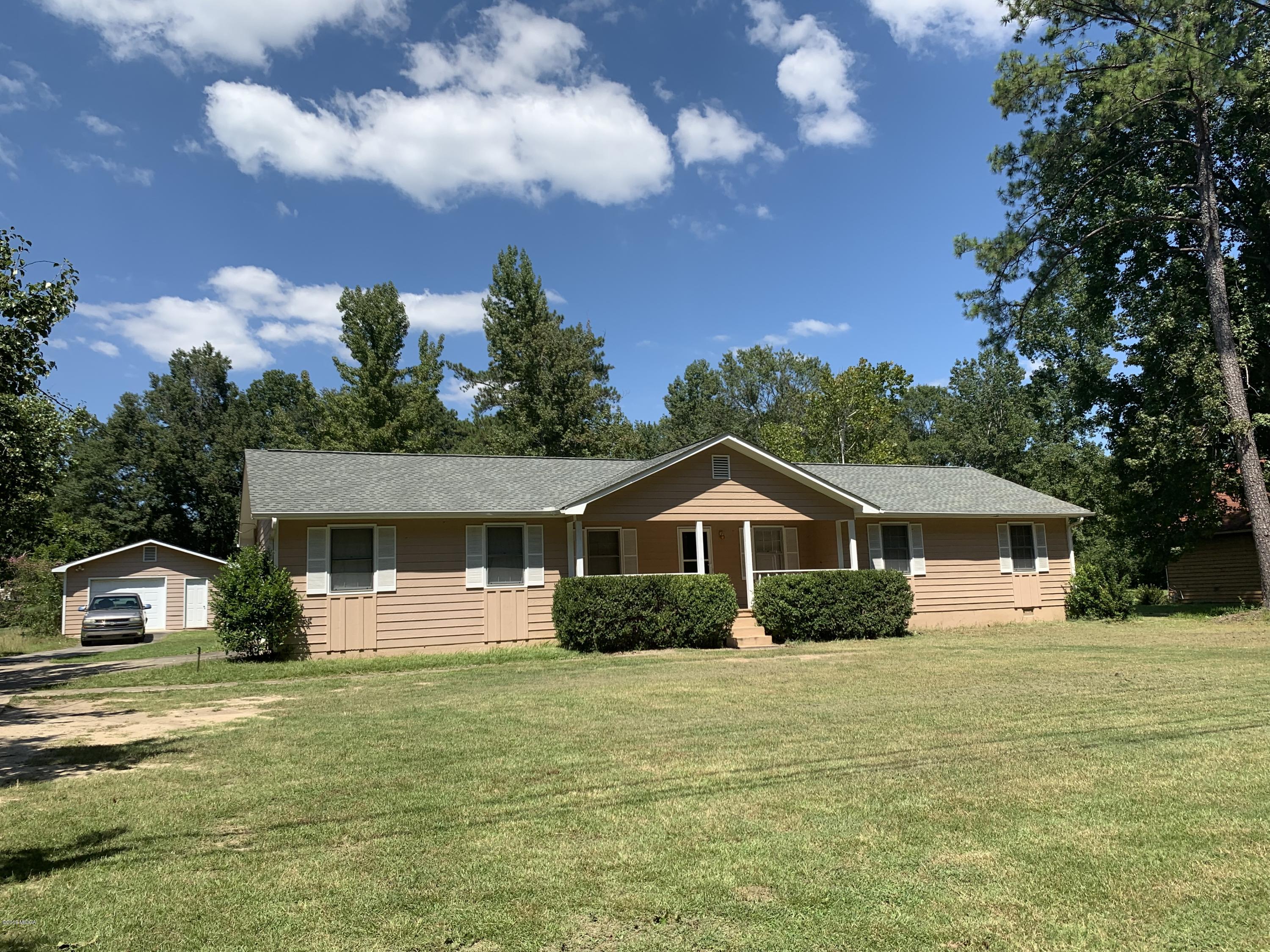 3295 Hartley Bridge Road Macon, GA 31216 - Photo 1 of 11 a front view of a house with a garden