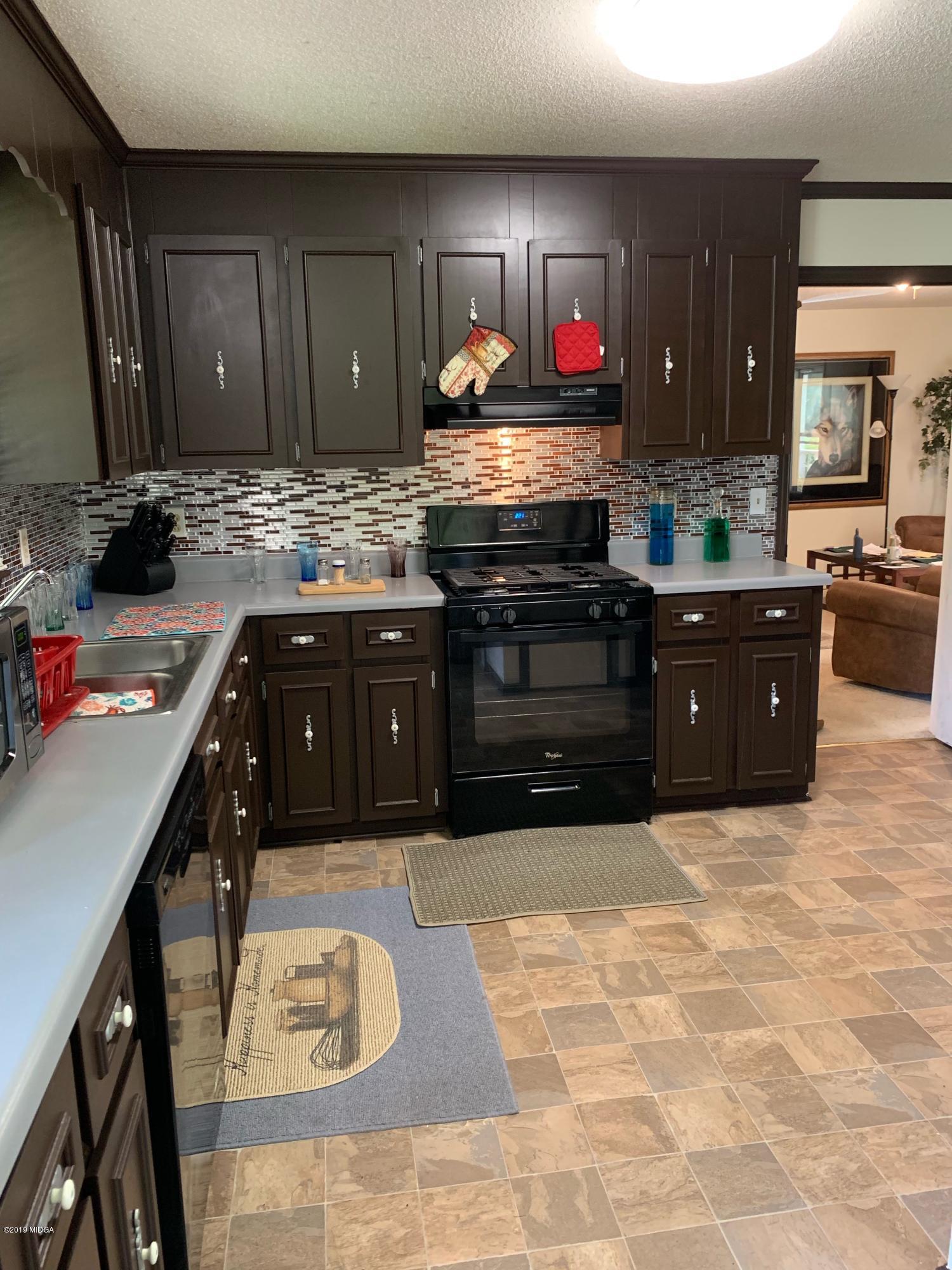 3295 Hartley Bridge Road Macon, GA 31216 - Photo 2 of 11 a kitchen with stainless steel appliances granite countertop a stove sink and cabinets