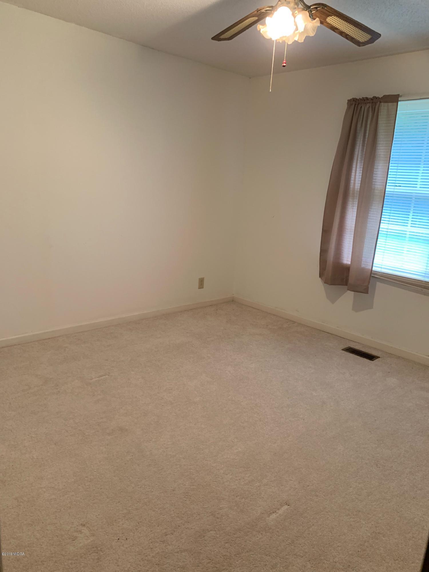 3295 Hartley Bridge Road Macon, GA 31216 - Photo 11 of 11 an empty room with a window
