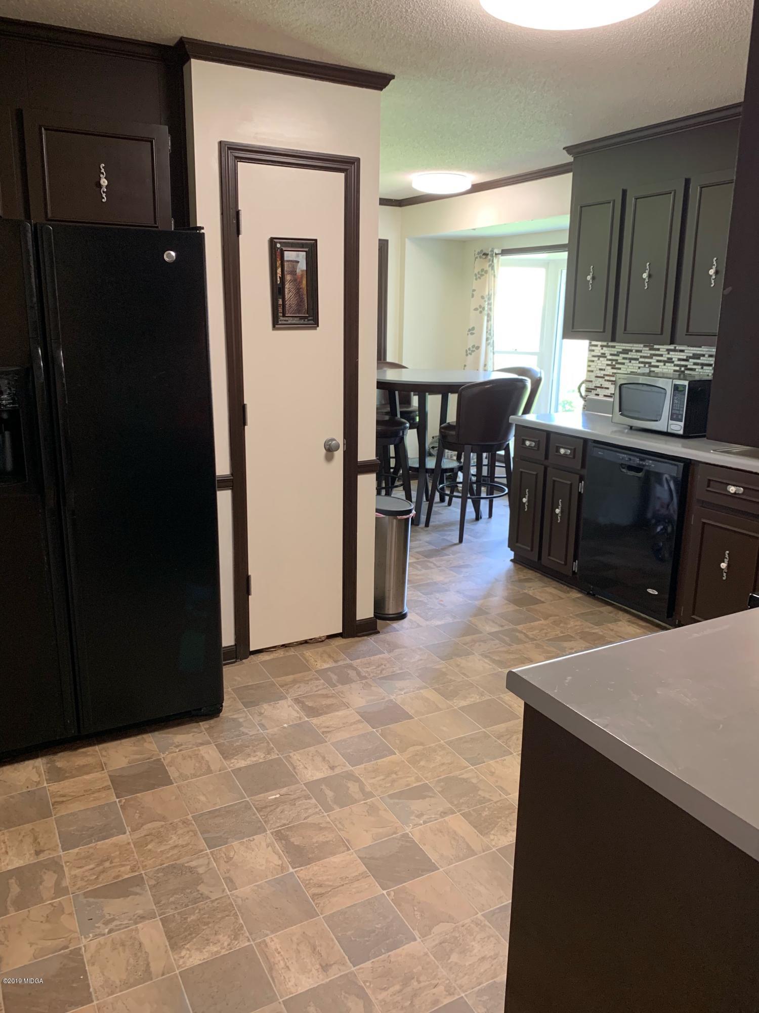 3295 Hartley Bridge Road Macon, GA 31216 - Photo 3 of 11 a view of a kitchen from the hallway