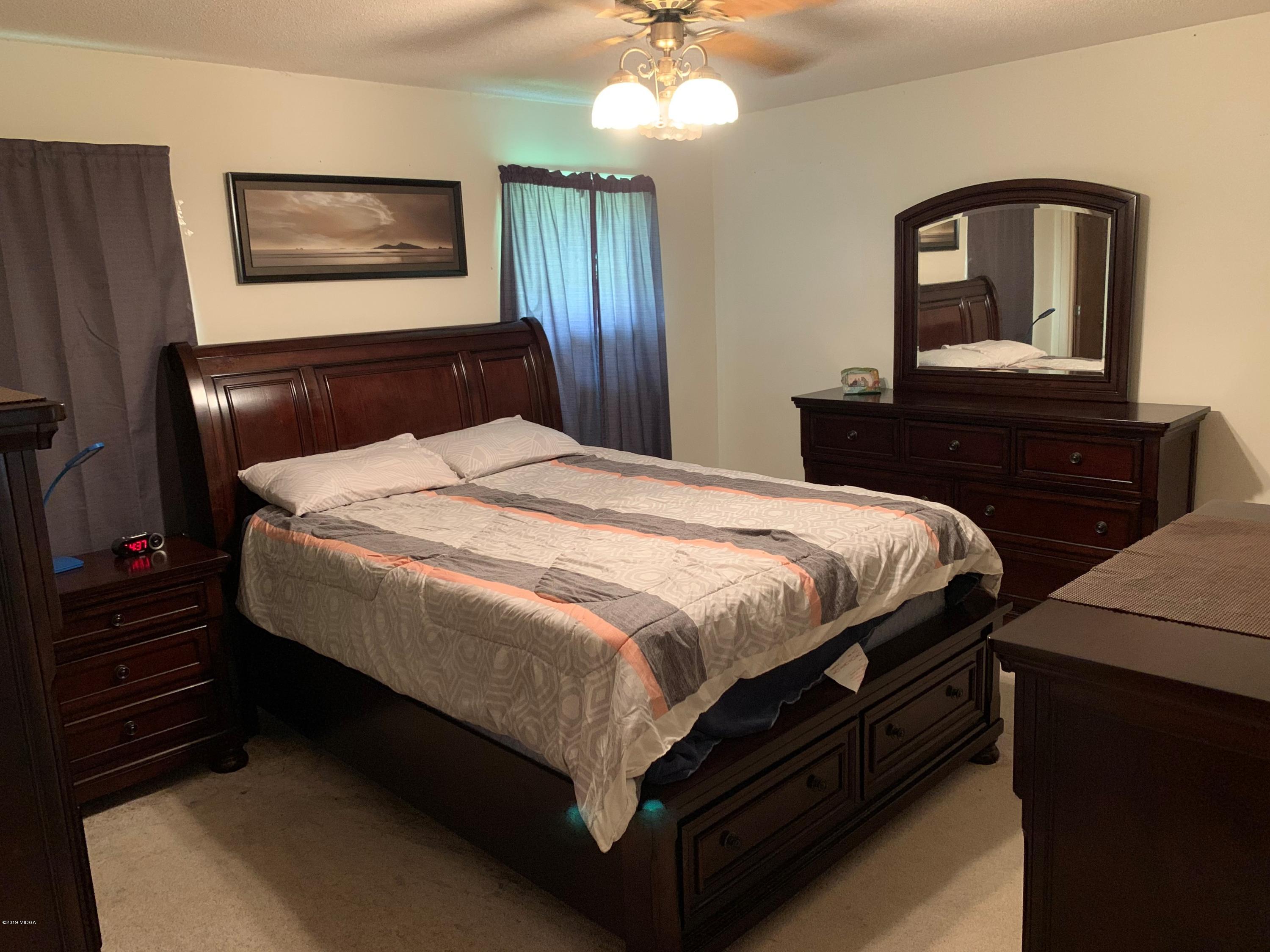 3295 Hartley Bridge Road Macon, GA 31216 - Photo 9 of 11 a bedroom with a bed and a dresser