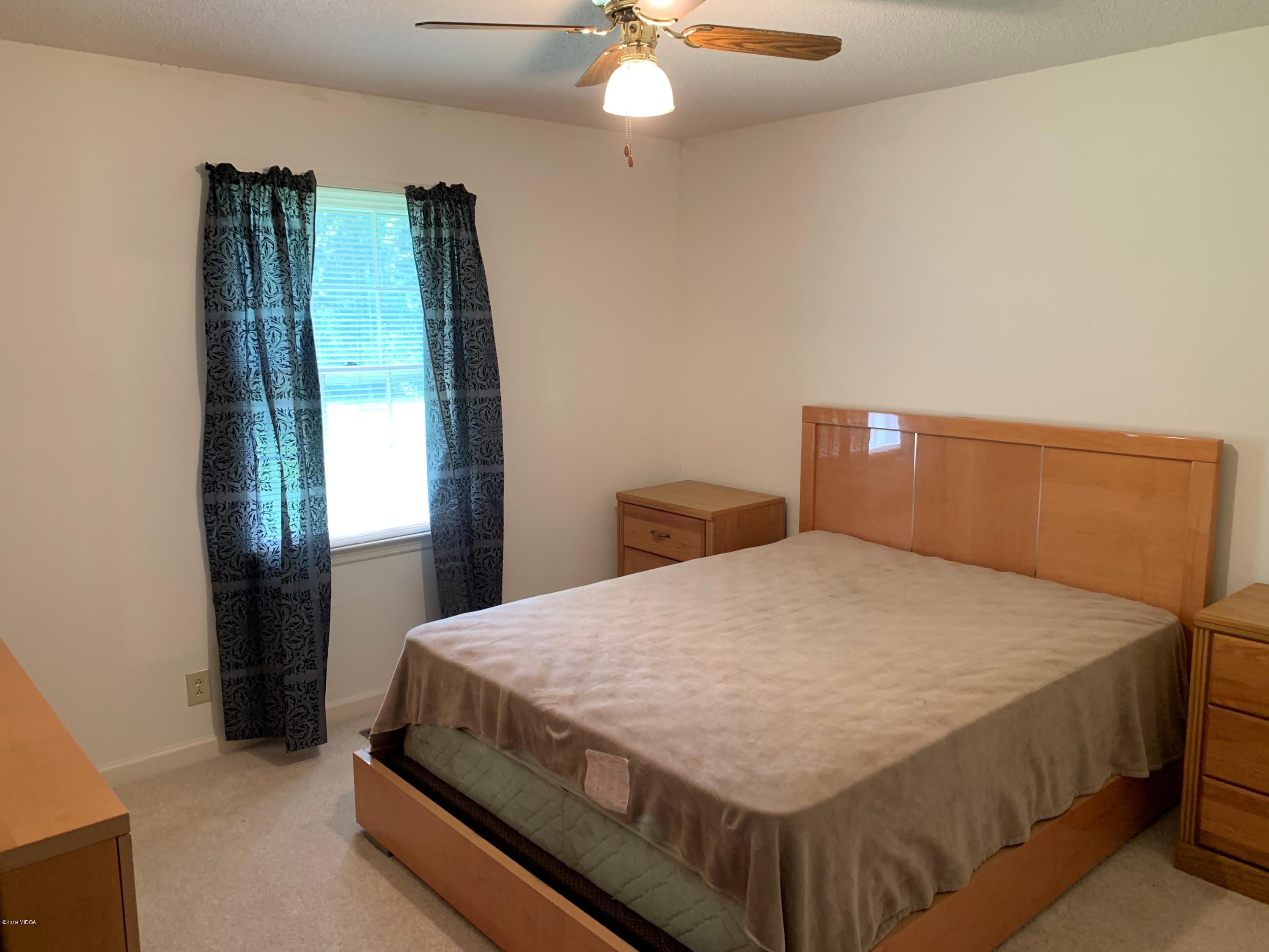 3295 Hartley Bridge Road Macon, GA 31216 - Photo 10 of 11 a bedroom with a bed and window