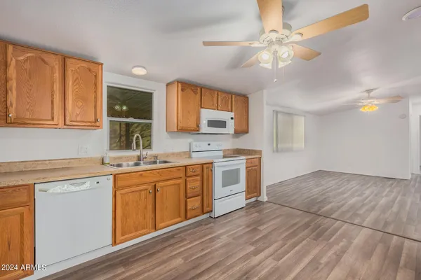 a kitchen with a sink cabinets and window