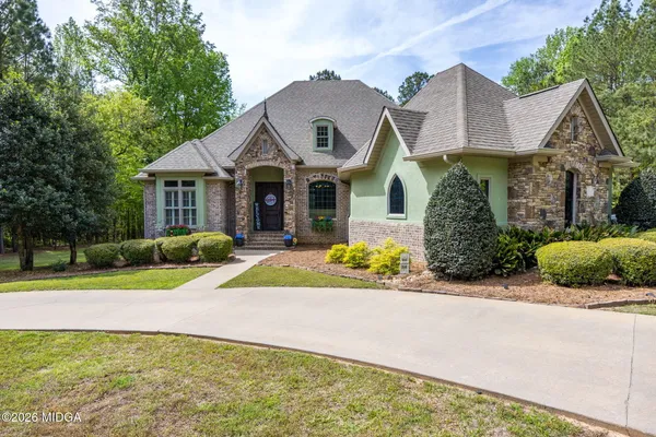 a front view of house with yard and green space