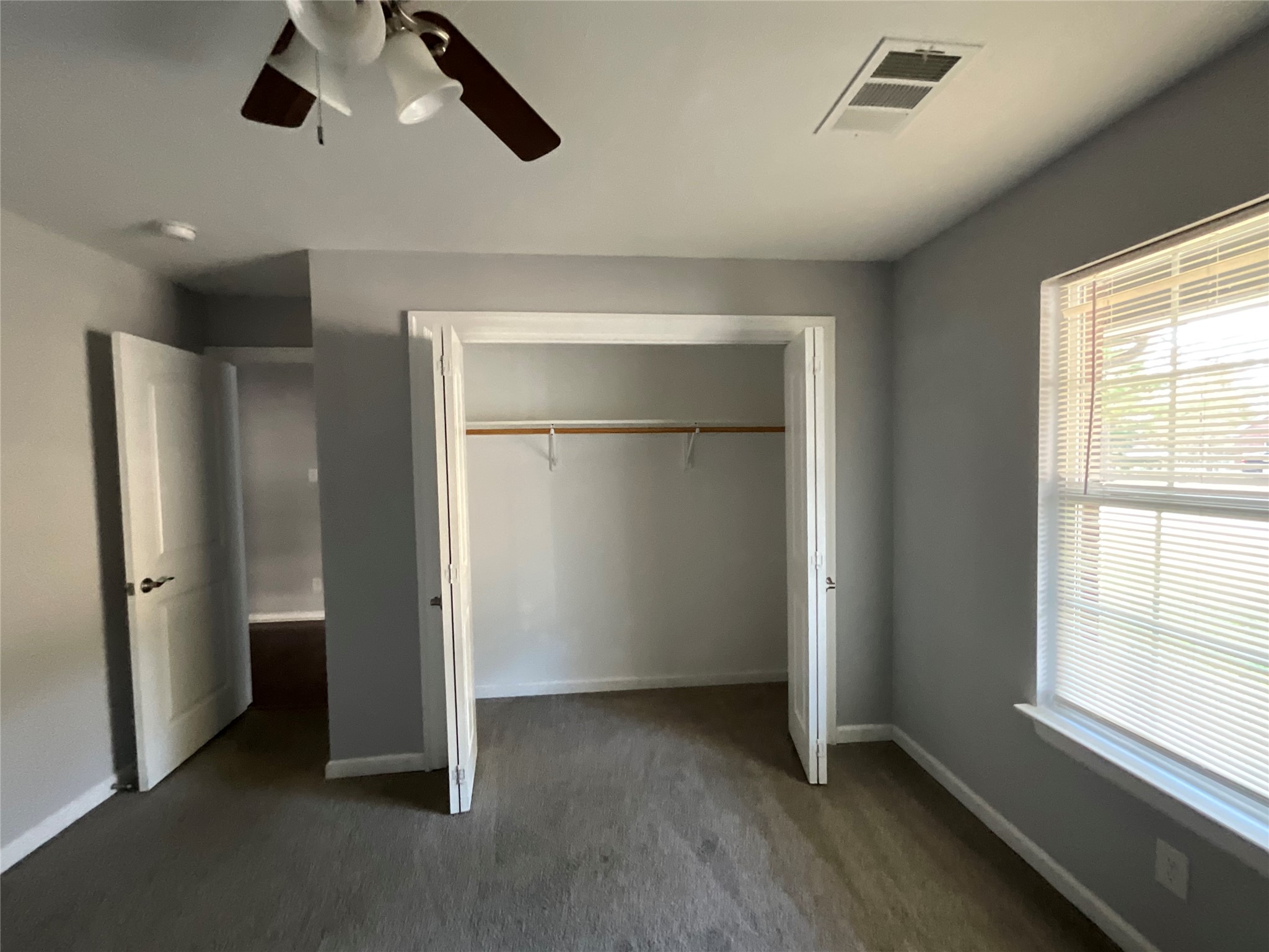 239 Old Firetower Road Bastrop, TX 78602 - Photo 34 of 39 Unfurnished bedroom with dark colored carpet, a closet, and ceiling fan