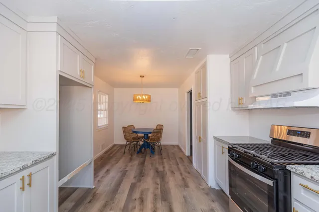 a kitchen with stainless steel appliances granite countertop a stove and a refrigerator