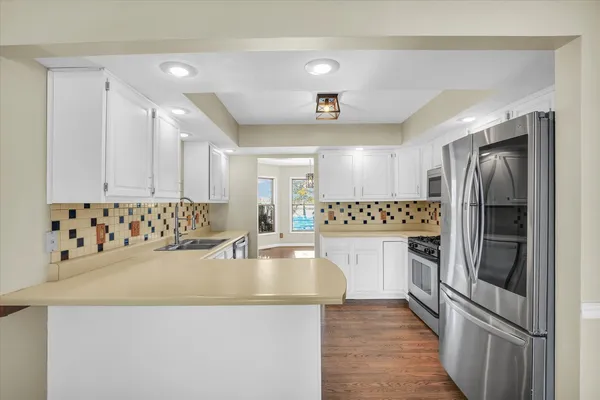 a kitchen with refrigerator and cabinets