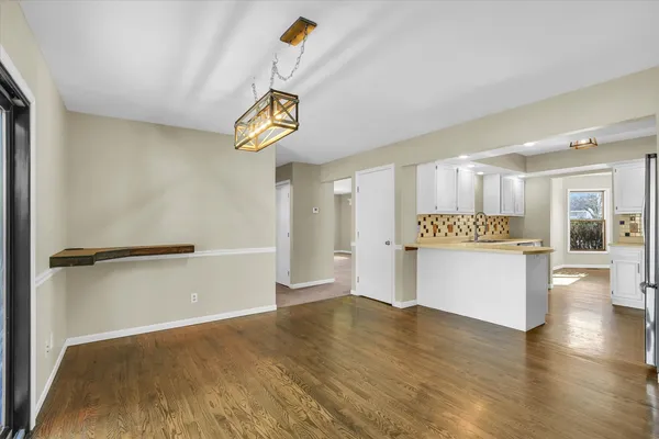 a view of an empty room and wooden floor
