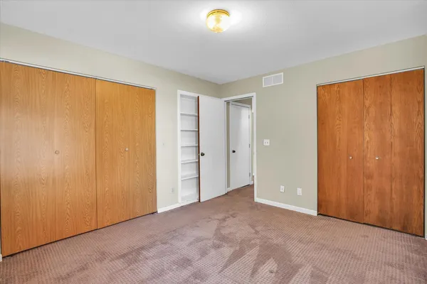 a view of an empty room and a window