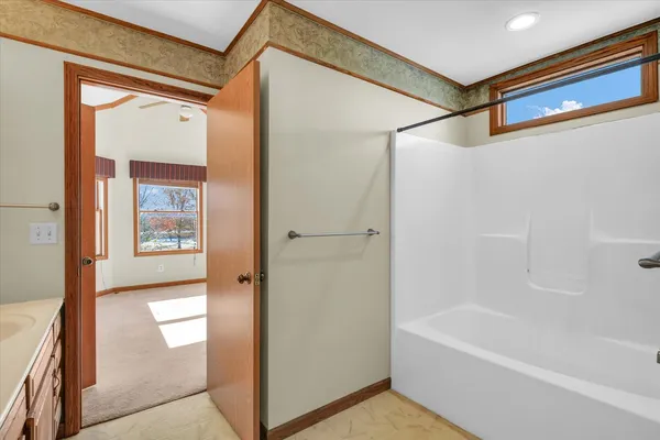a bathroom with a bathtub and a shower