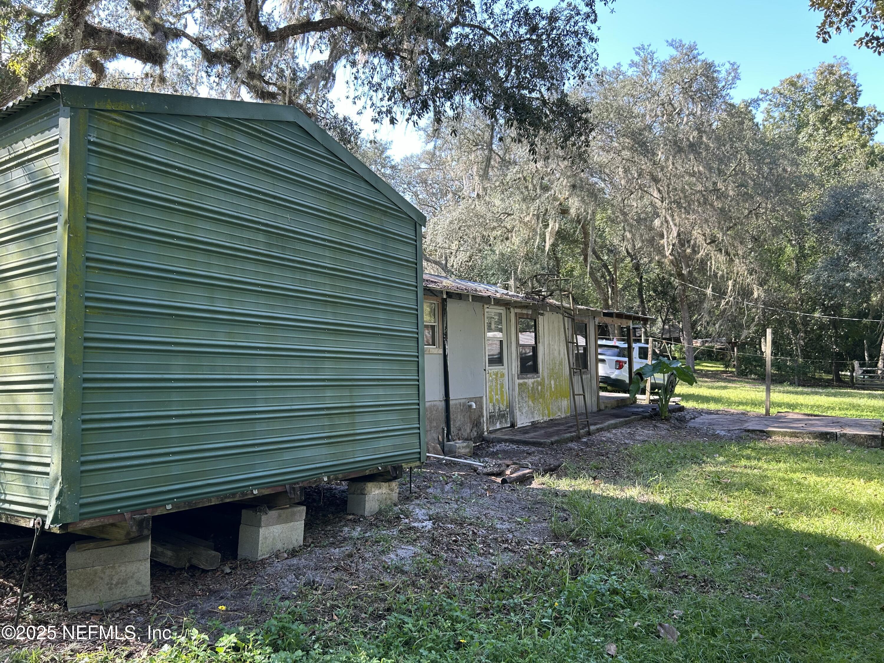 218 Deans Creek Road Palatka, FL 32134 - Photo 3 of 8 a view of a house with a yard and sitting area