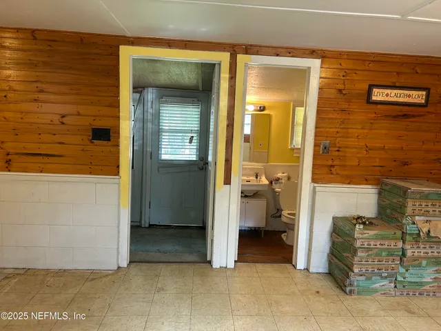 a view of a hallway with bathroom