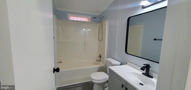 a bathroom with a sink a toilet a shower and a mirror