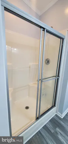 a bathroom with a glass shower door