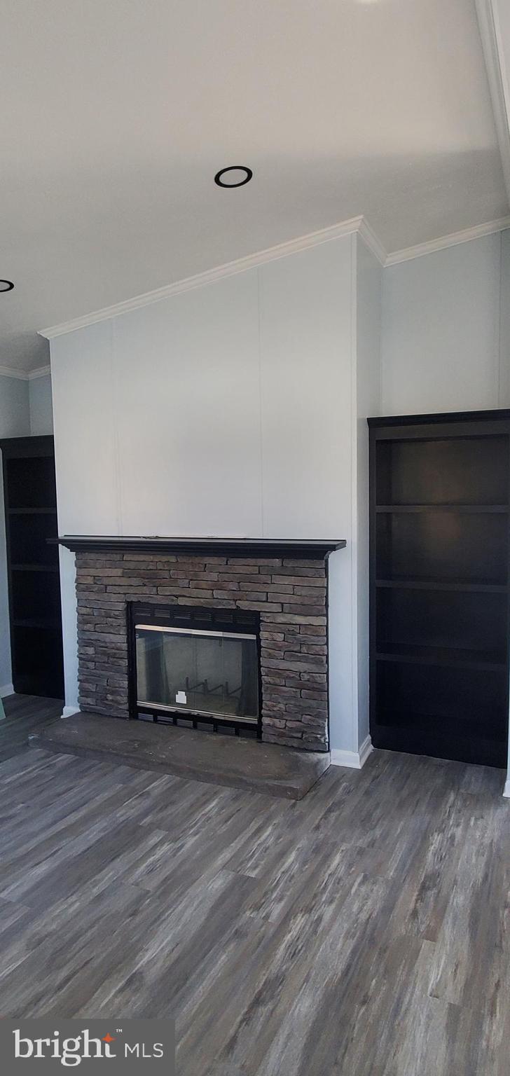 1903 Bennett Road Aberdeen, MD 21001 - Photo 4 of 8 a view of an empty room with wooden floor and a fireplace