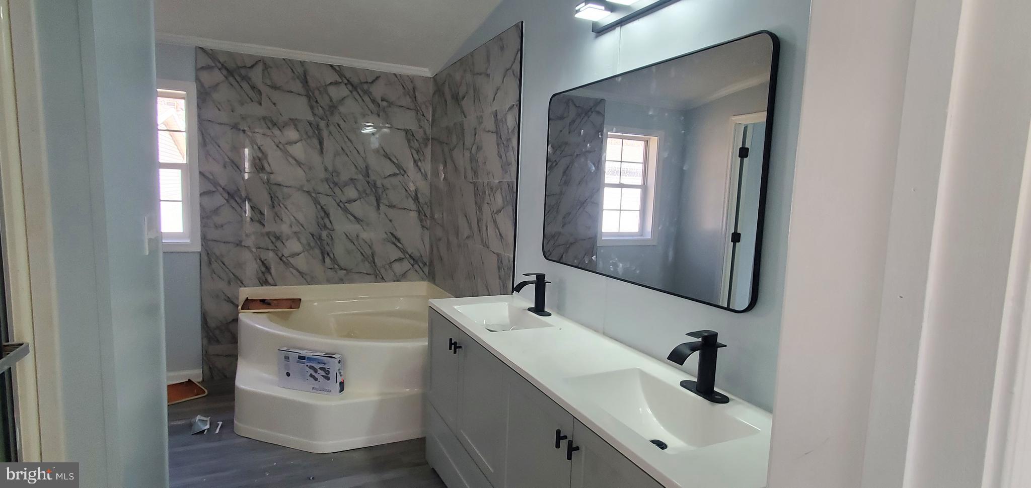 1903 Bennett Road Aberdeen, MD 21001 - Photo 6 of 8 a bathroom with a sink a mirror and a bathtub