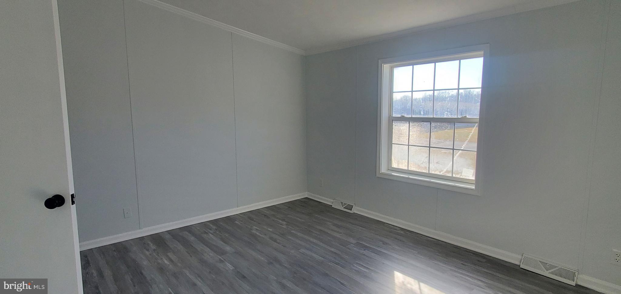 1903 Bennett Road Aberdeen, MD 21001 - Photo 7 of 8 an empty room with wooden floor and windows