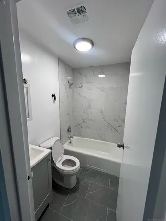 a bathroom with a bathtub and a toilet