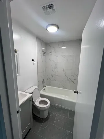 a bathroom with a bathtub and a toilet