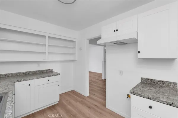 a kitchen with cabinets appliances and a counter space