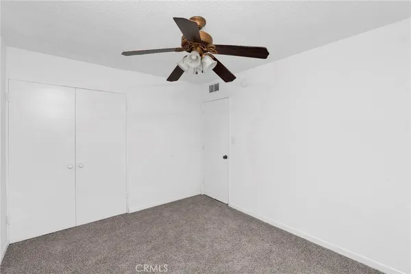 a view of a room with a ceiling fan