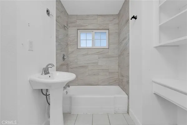 a bathroom with a sink a mirror and a bathtub