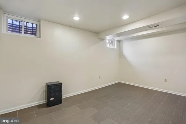 a bathroom with a sink vanity mirror and toilet