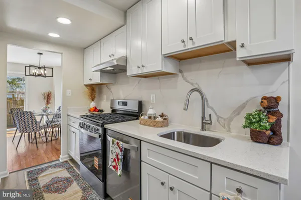 a living room with furniture a chandelier and a rug