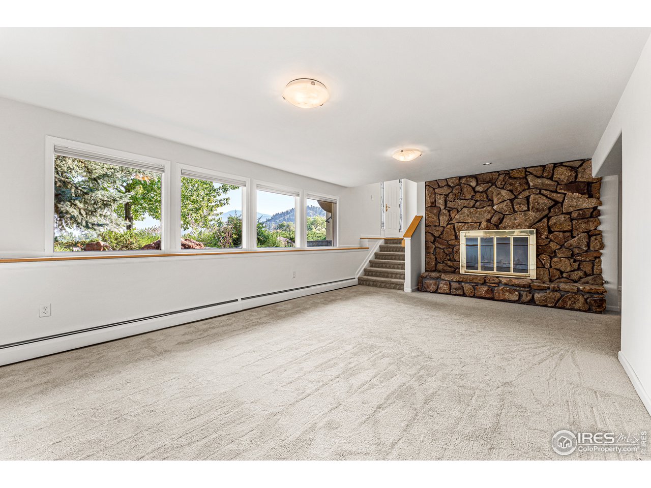 3725 Spring Valley Road Boulder, CO 80304 - Photo 26 of 40 Mountain views from the lower recreation room + a gas log fireplace.