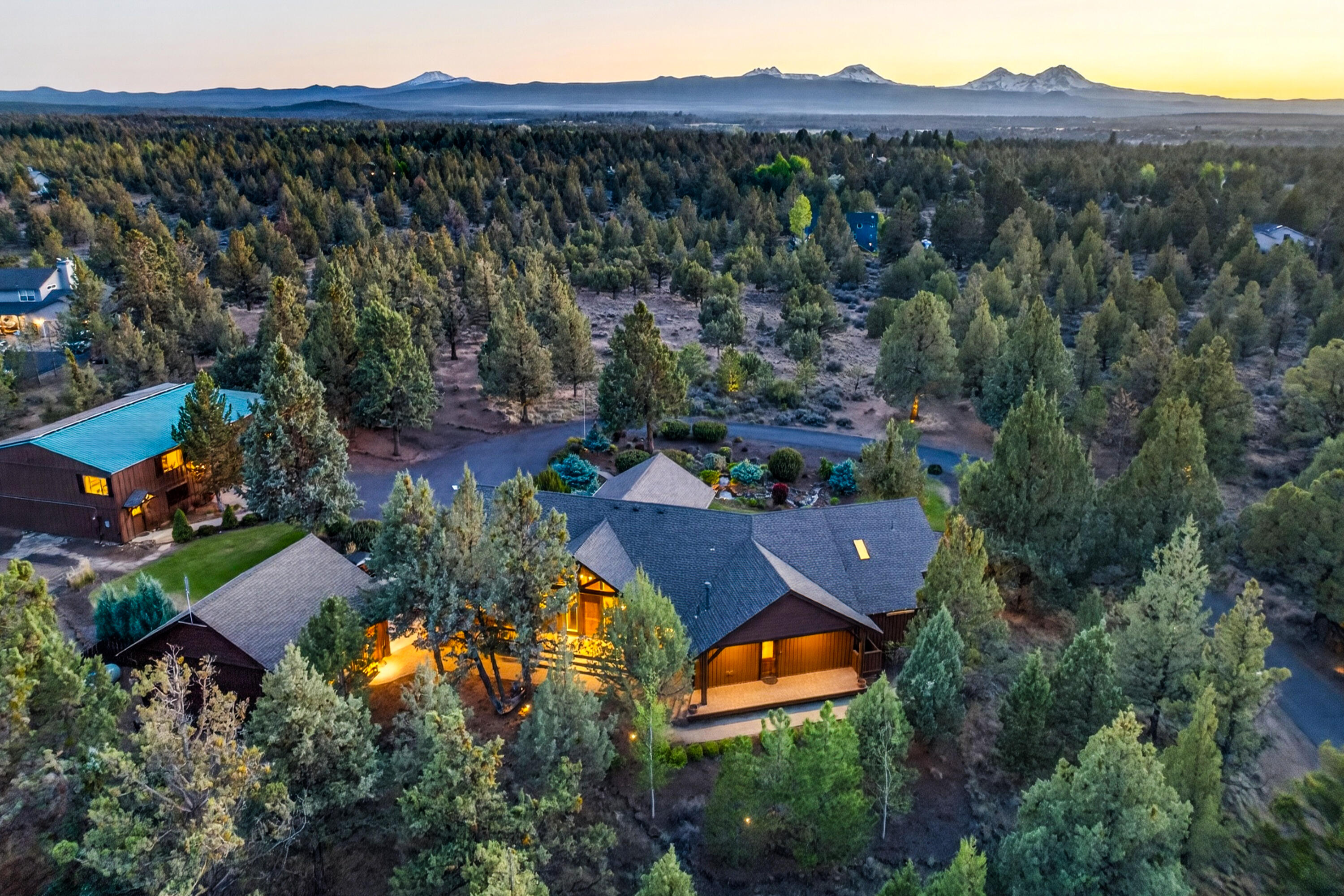 64145 Hunnell Road Bend, OR 97703 - Photo 1 of 65 Sweeping full Cascade Mountain range views define this rare 9.46-acre offering, where a custom single-level PacWest-built home, detached garage, expansive shop, and finished upper-level guest/flex quarters come together in an exceptional Central Oregon setting.
