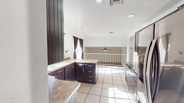 a kitchen with stainless steel appliances granite countertop a refrigerator and a sink