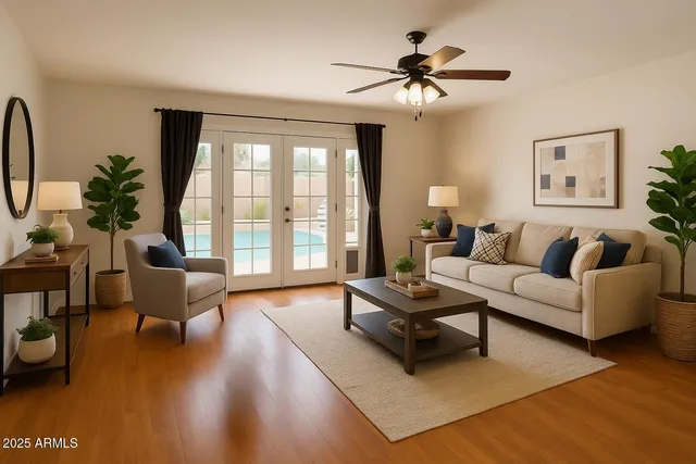 a living room with furniture a table and a large window