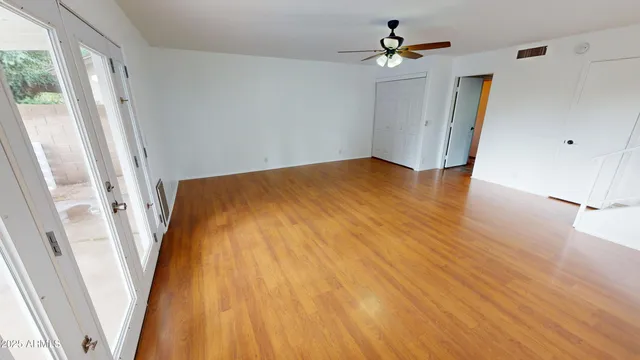 wooden floor in an empty room with a window
