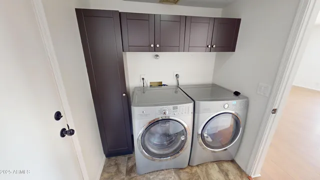 a view of storage and utility room with washer and dryer