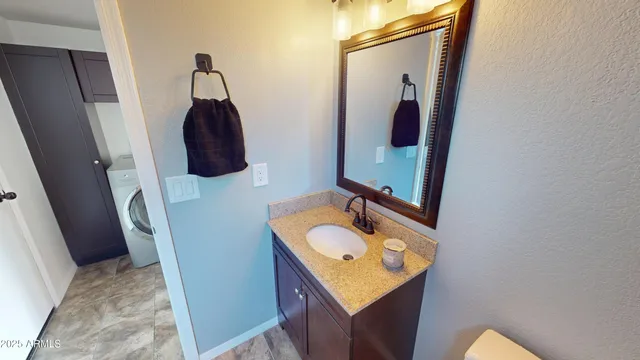 a bathroom with a sink vanity and mirror