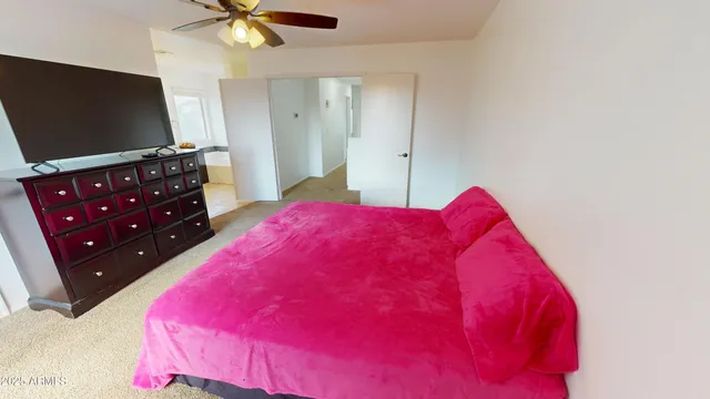 a bedroom with a bed and a flat screen tv