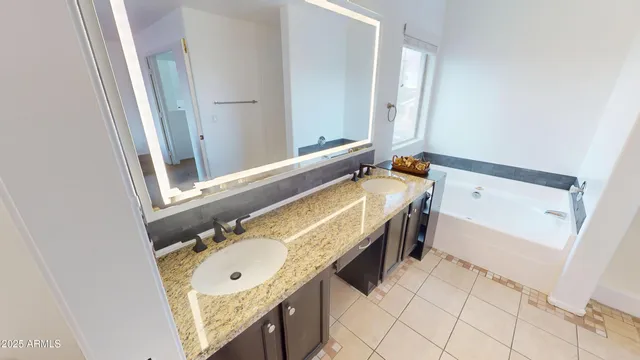 a bathroom with a bathtub a sink and a mirror