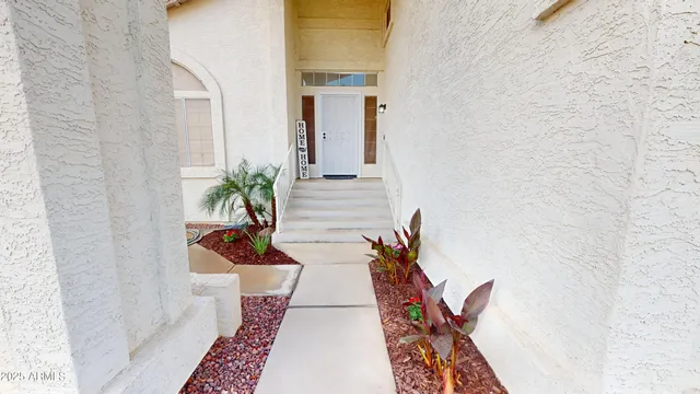 a vase with flowers sitting on a floor