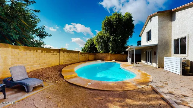 a view of a swimming pool with a lounge chairs