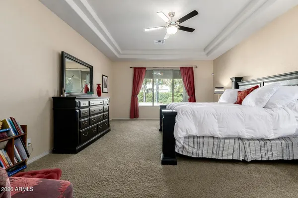 a bedroom with a bed and a chandelier