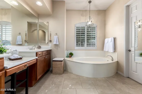 a spacious bathroom with a bathtub sink and mirror
