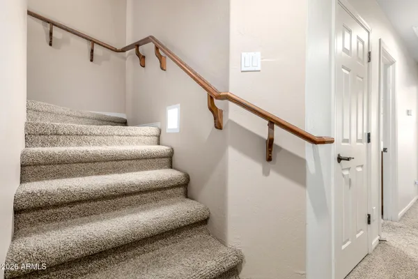 a view of staircase with lots of frames on wall
