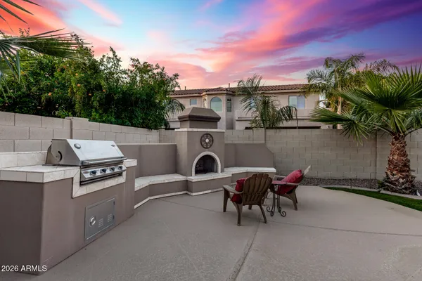 a view of a chairs and table in the back yard of the house