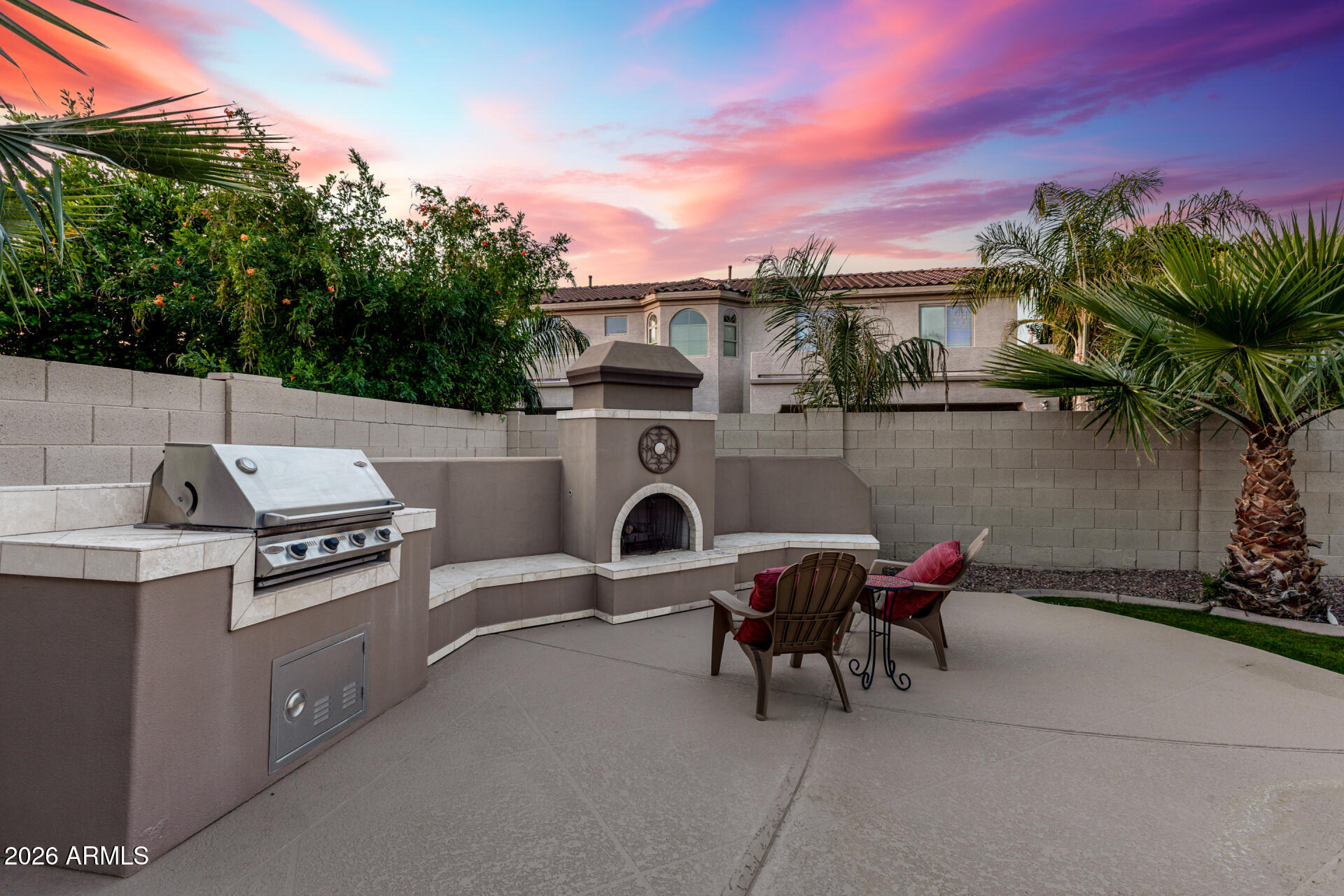 4614 East Reins Road Gilbert, AZ 85297 - Photo 3 of 51 a view of a chairs and table in the back yard of the house