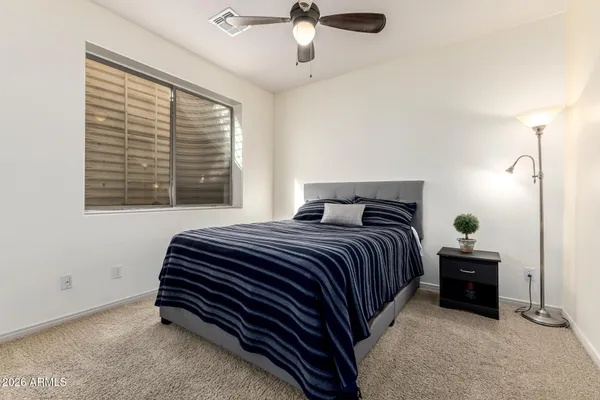 a bedroom with a bed and a window