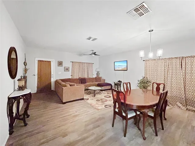 a living room with furniture a rug and a chandelier