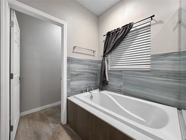 a bathroom with a bathtub and a shower