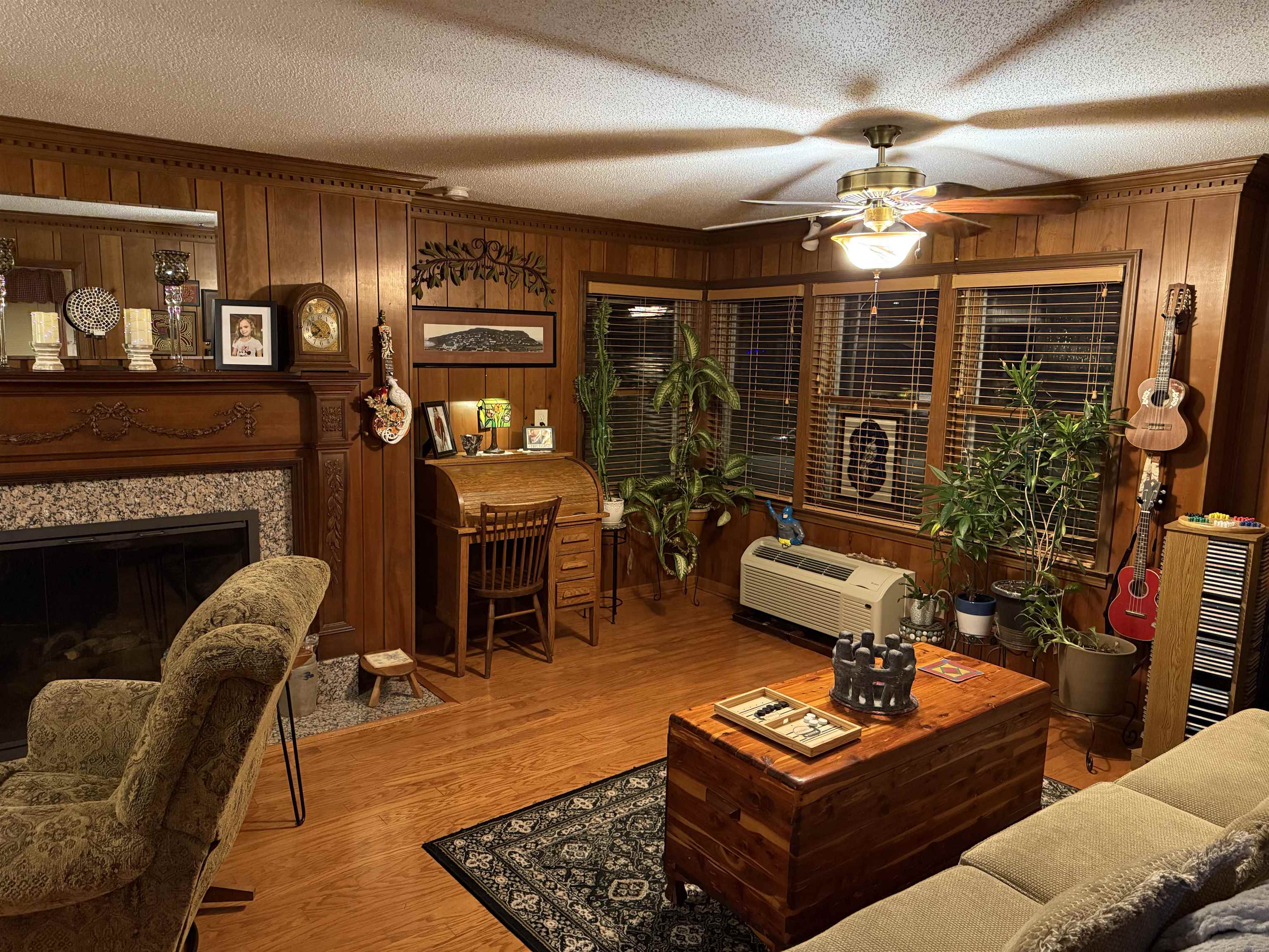 3194 Lammermuir Road Memphis, TN 38128 - Photo 11 of 37 Living area featuring wood paneling, wood-finish flooring, and multiple windows with blinds
