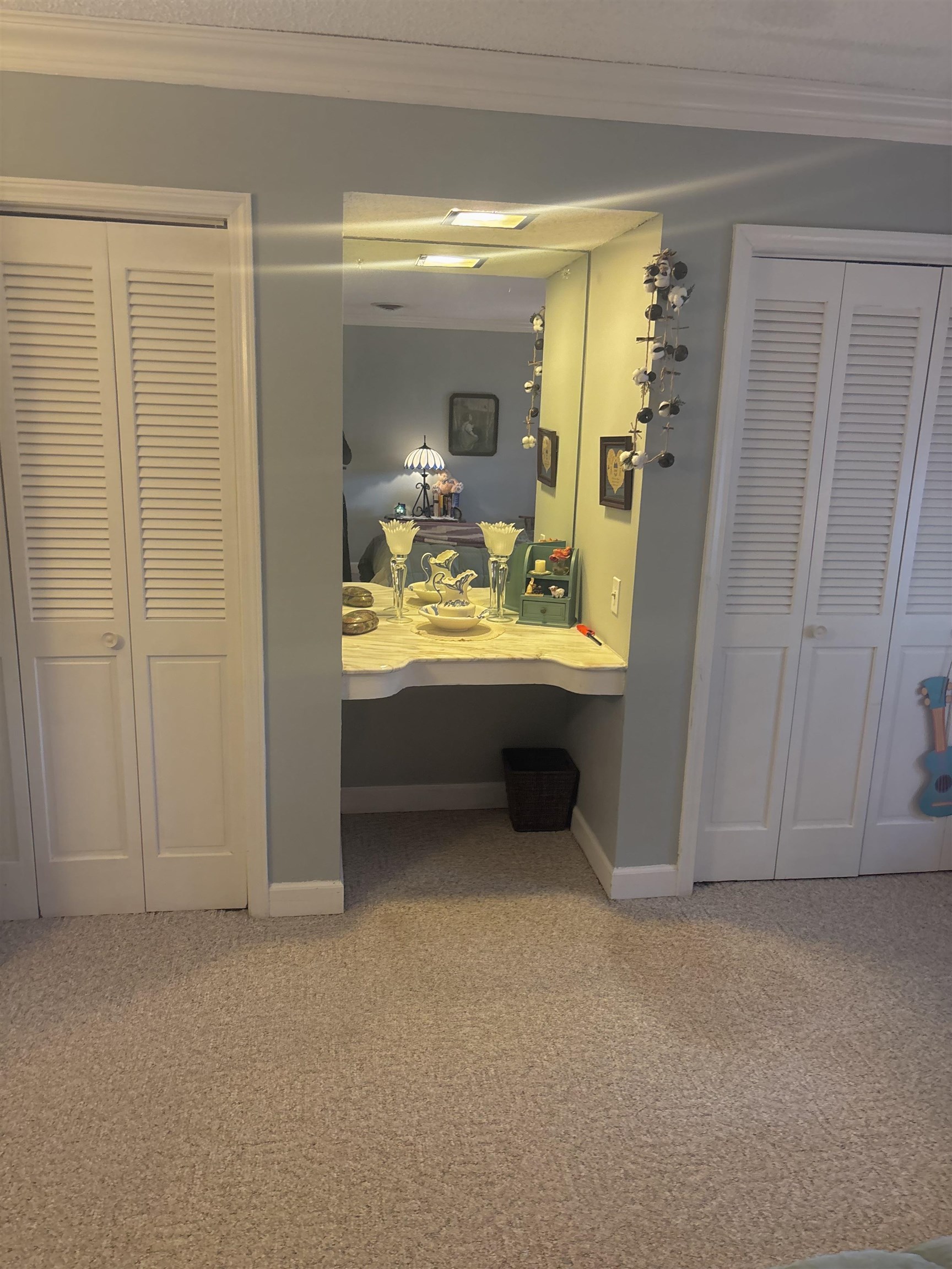 3194 Lammermuir Road Memphis, TN 38128 - Photo 28 of 37 Built-in vanity with reflective wall-mounted mirror, flanked by two louvered bifold closet doors